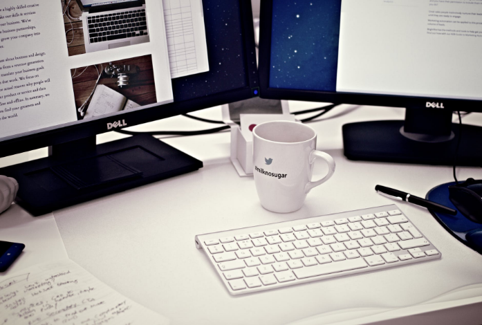 two computers and a glass of coffee